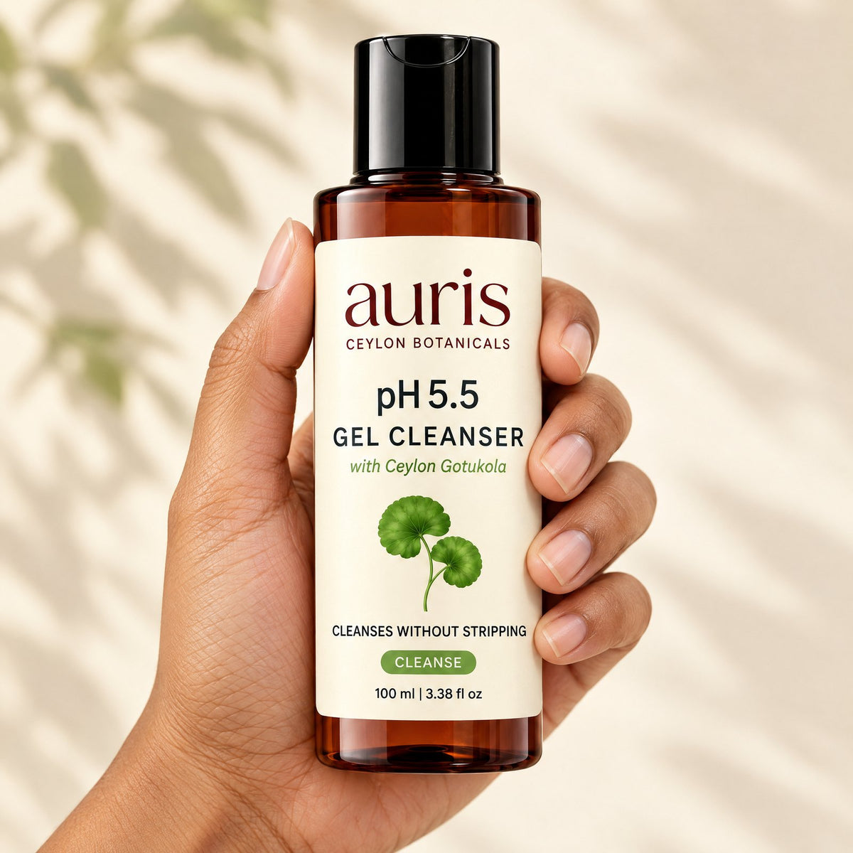 Auris pH 5.5 Gel Cleanser held in hand, label facing the camera