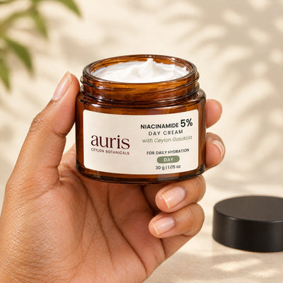 Auris Niacinamide 5% Day Cream held in hand, label facing the camera