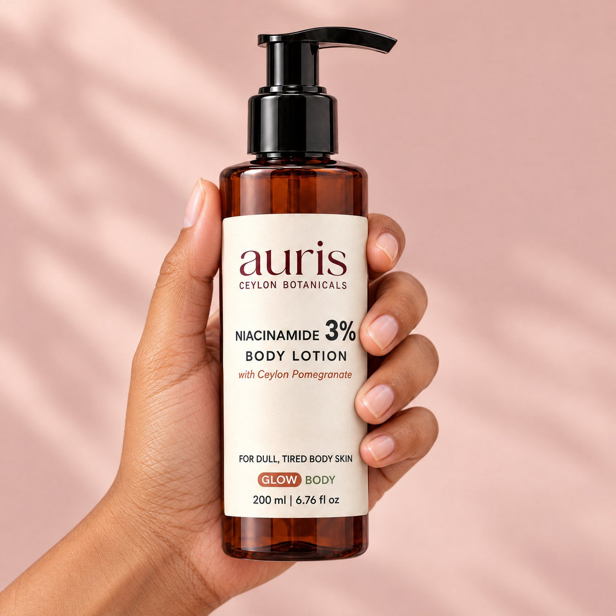 Auris GLOW Niacinamide 3% Body Lotion held in hand, label facing the camera