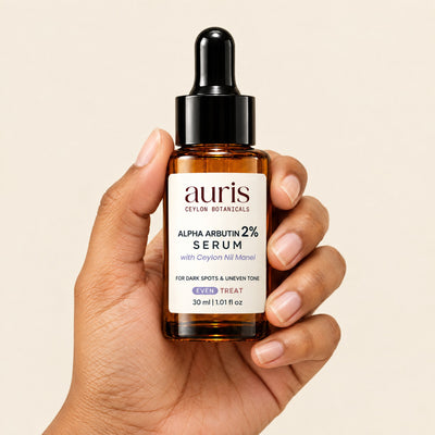 Auris EVEN Alpha Arbutin 2% Serum held in hand, label facing the camera