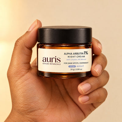 Auris EVEN Alpha Arbutin 1% Night Cream held in hand, label facing the camera