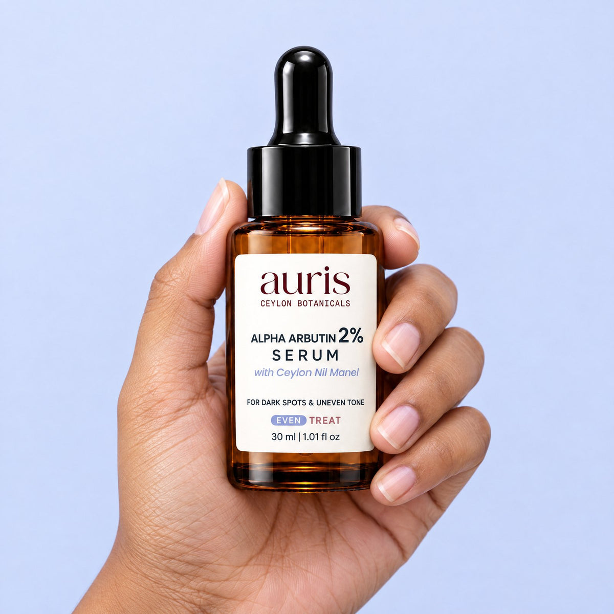 OLD (restored for review) — Auris EVEN Alpha Arbutin 2% Serum held in hand, label facing the camera