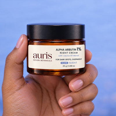 OLD (restored for review) — Auris EVEN Alpha Arbutin 1% Night Cream held in hand, label facing the camera